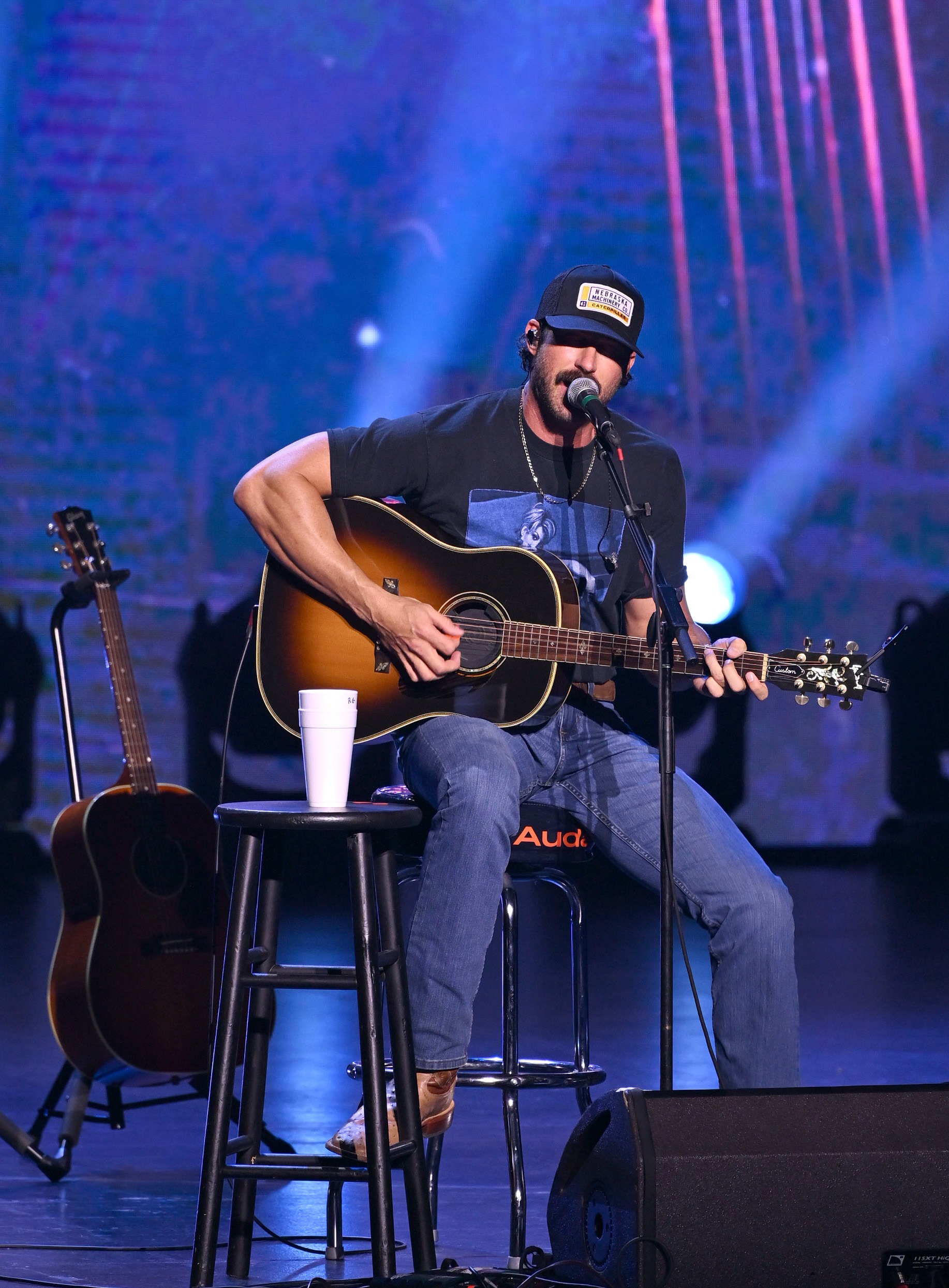 Riley Green playing acoustic guitar
