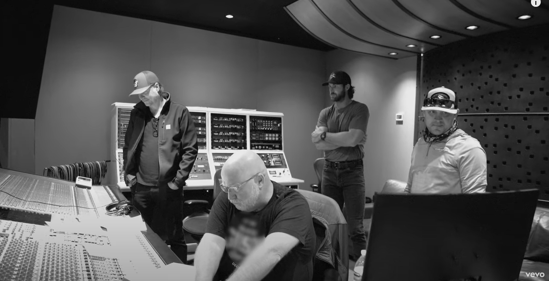 Studio recording session with music production equipment in warm lighting